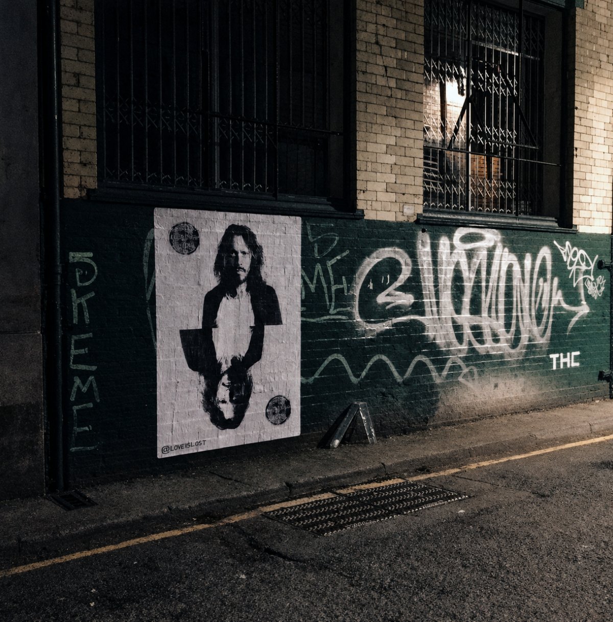 Love is Lost — poster on graffiti wall